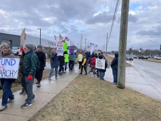 People in Ann Arbor protesting Elon Musk
