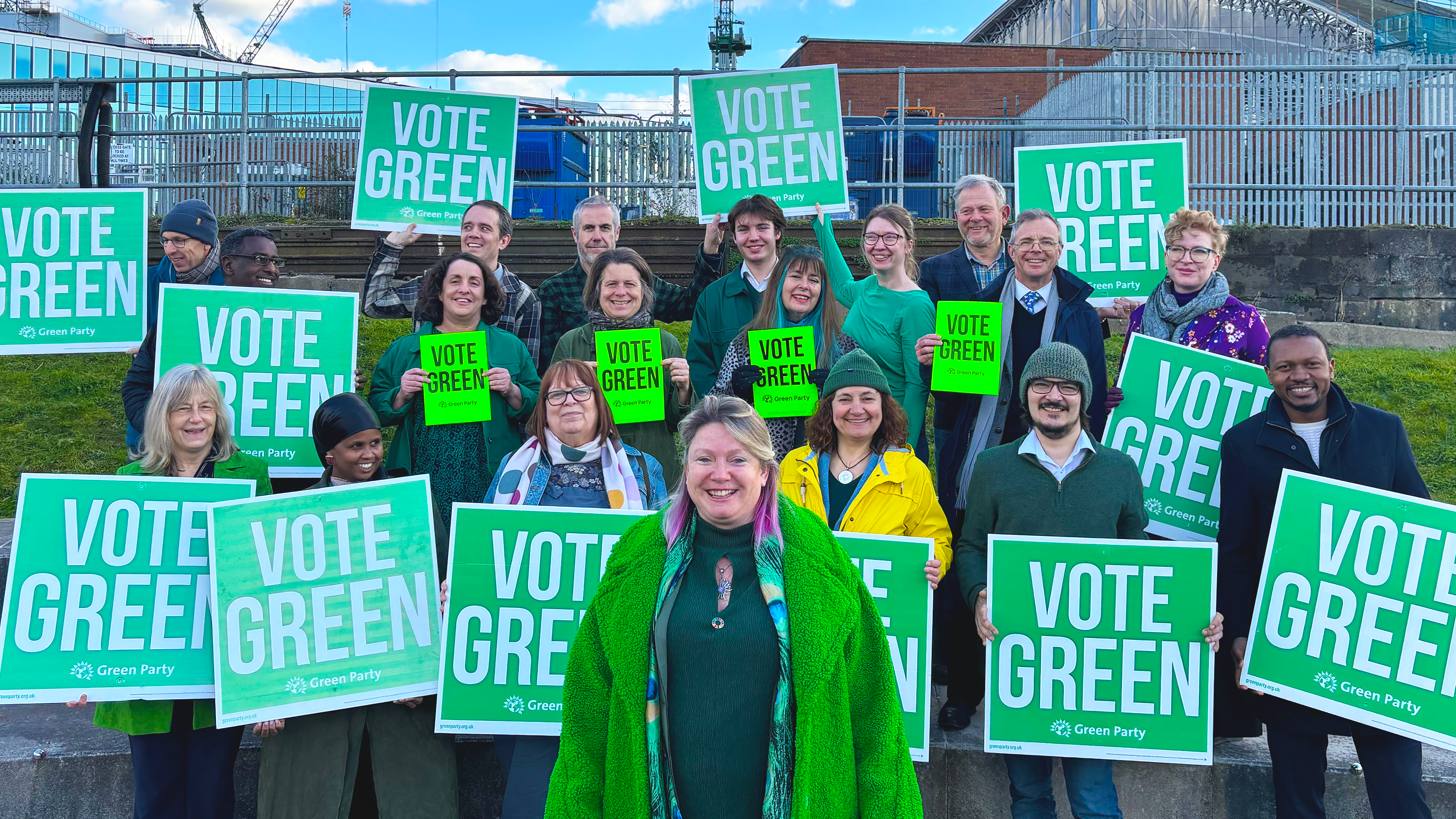 Mary Page and a group of Green Party supporters displaying VOTE GREEN signs