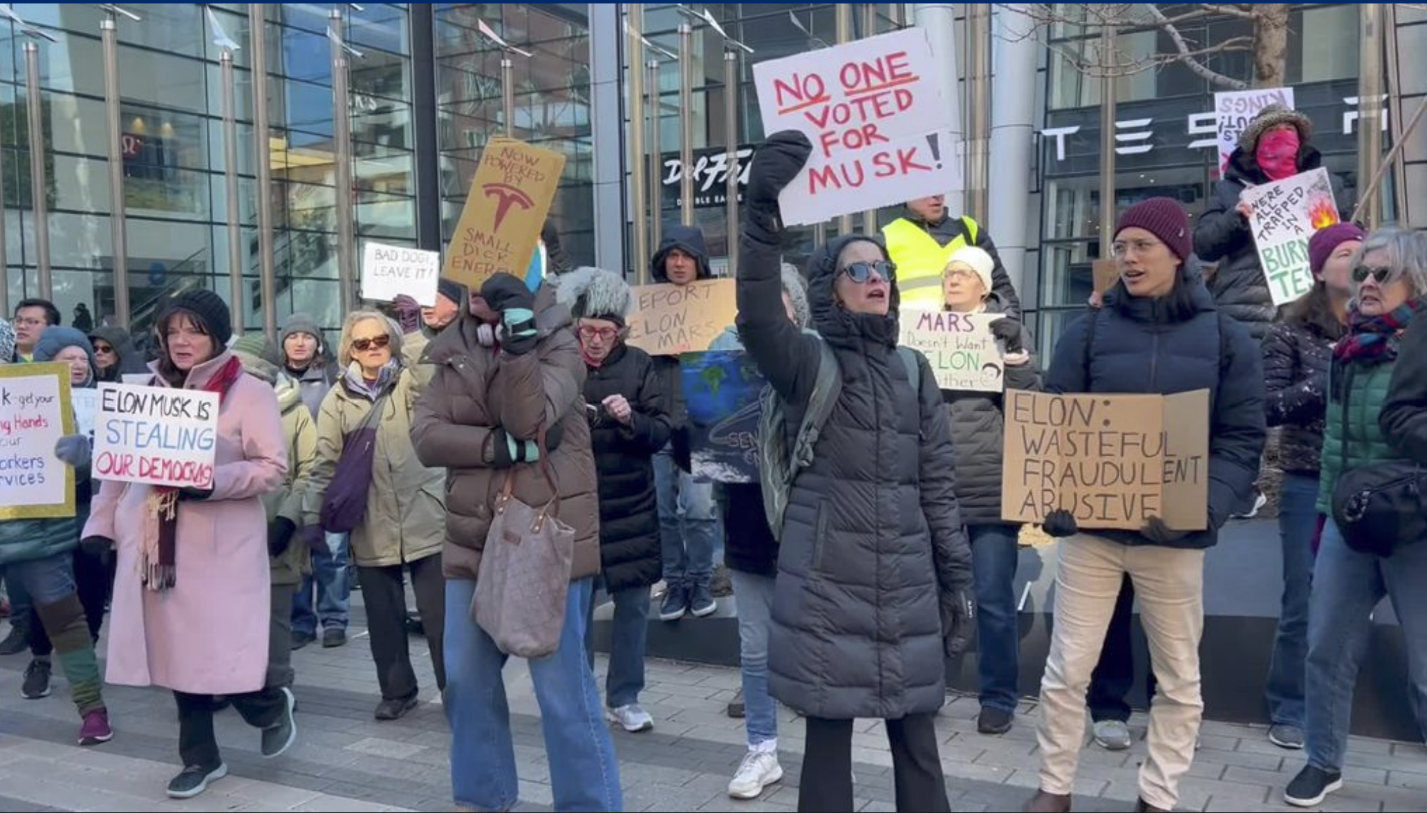 Protestors in front of the Boston Tesla showroom