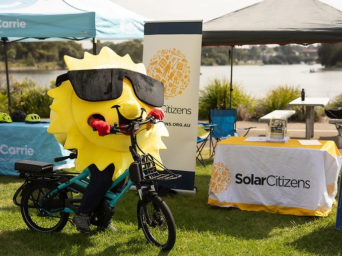 Solar Citizens 'Sunny' Mascot on e-bike at Cahill Park, Wolli Cree, Sydney