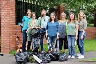 Group of people posing for photo after doing a litter pick