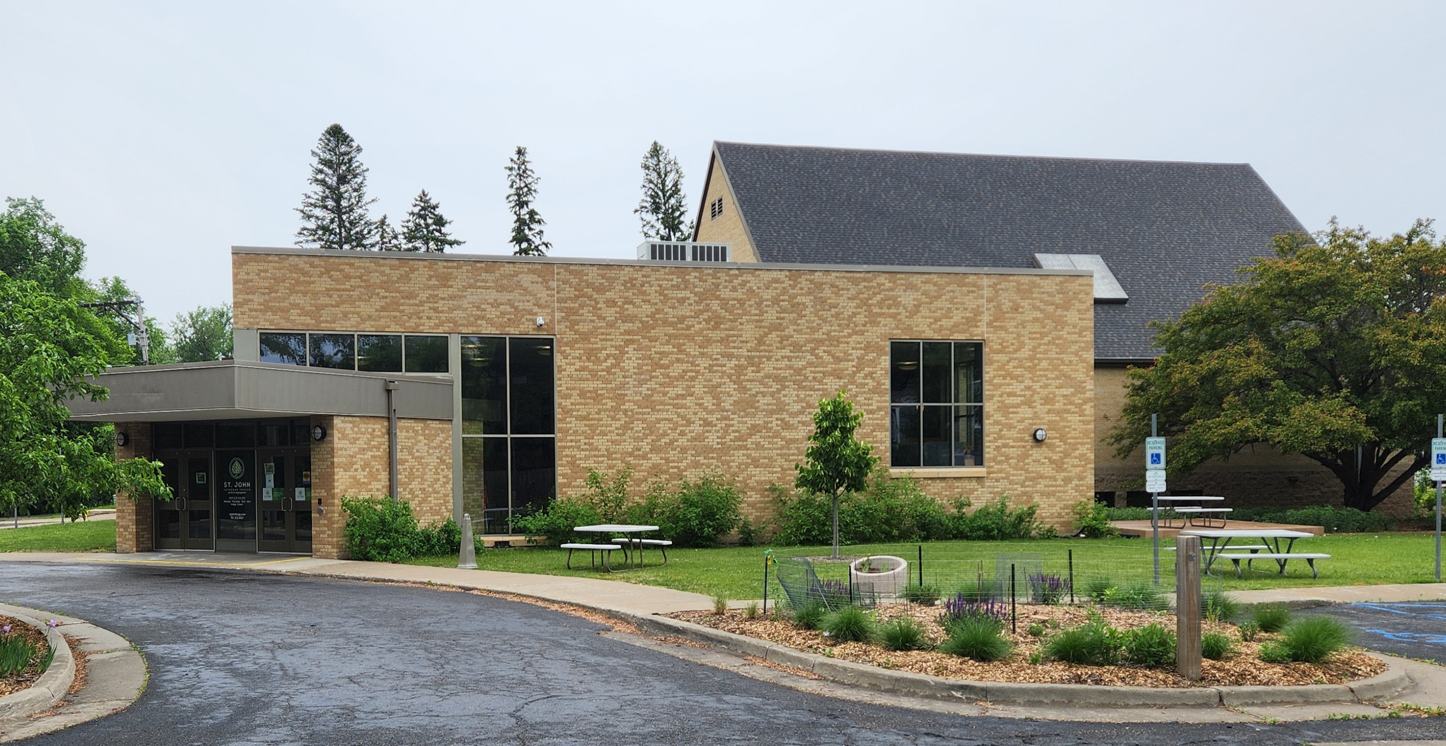 Photo of entrance (at left in photo; Northeast corner) of St. John's, and outdoor event area.