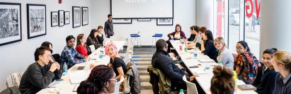 People sitting at tables in the conference room