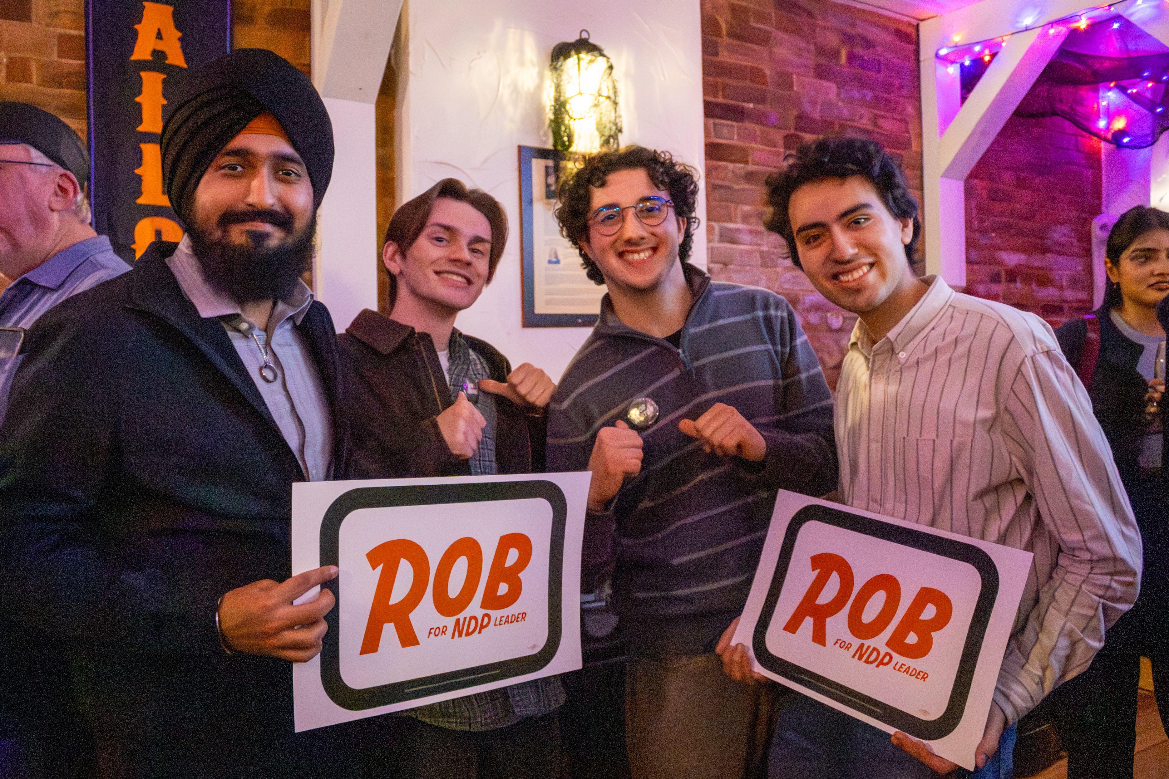 Young people holding Rob signs