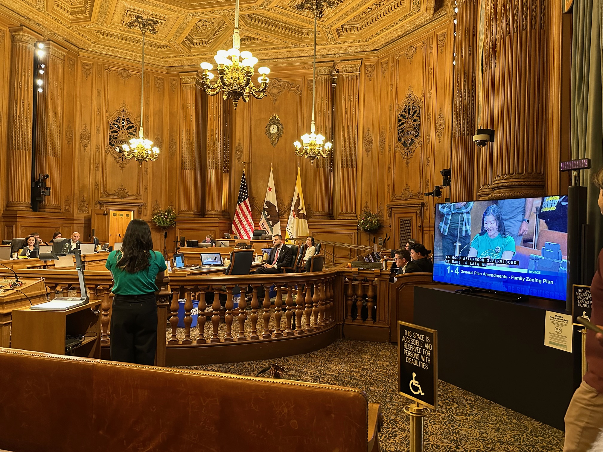 a woman giving public comment at SF City Hall