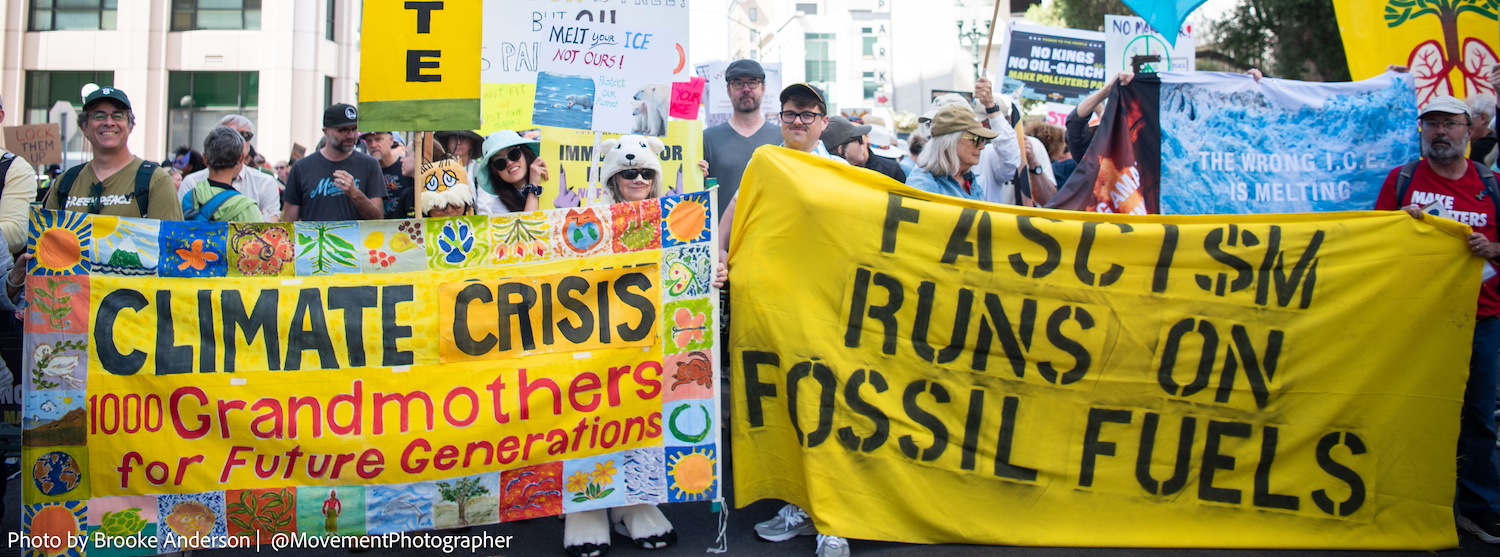 Photo of two yellow banners from the No Kings Day climate contingent