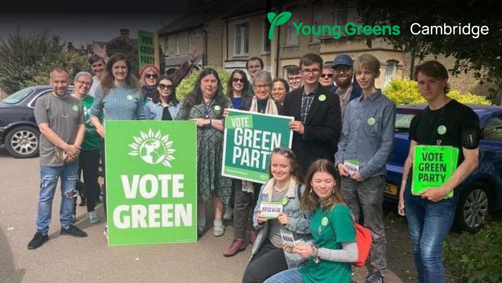 A group of Green Party members holding 'Vote Green' signs