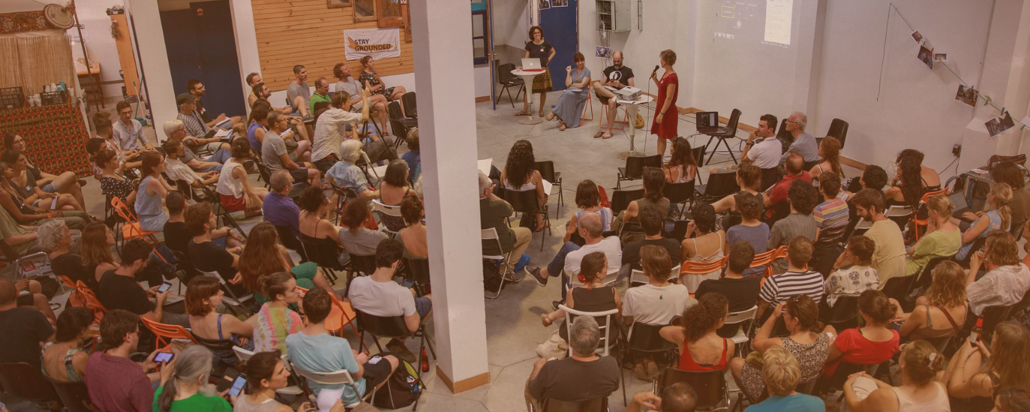 A photo of a room full of people attending a talk on fighting the aviation industry