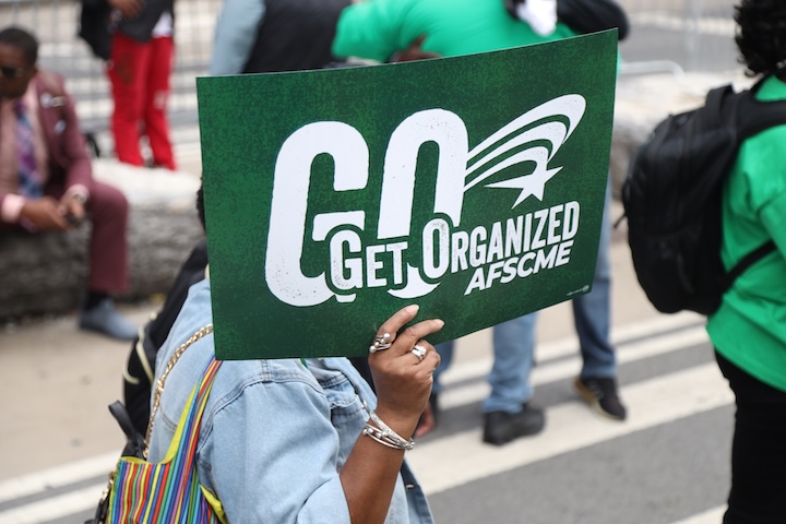 AFSCME member holds green rally sign that says "Get Organized"