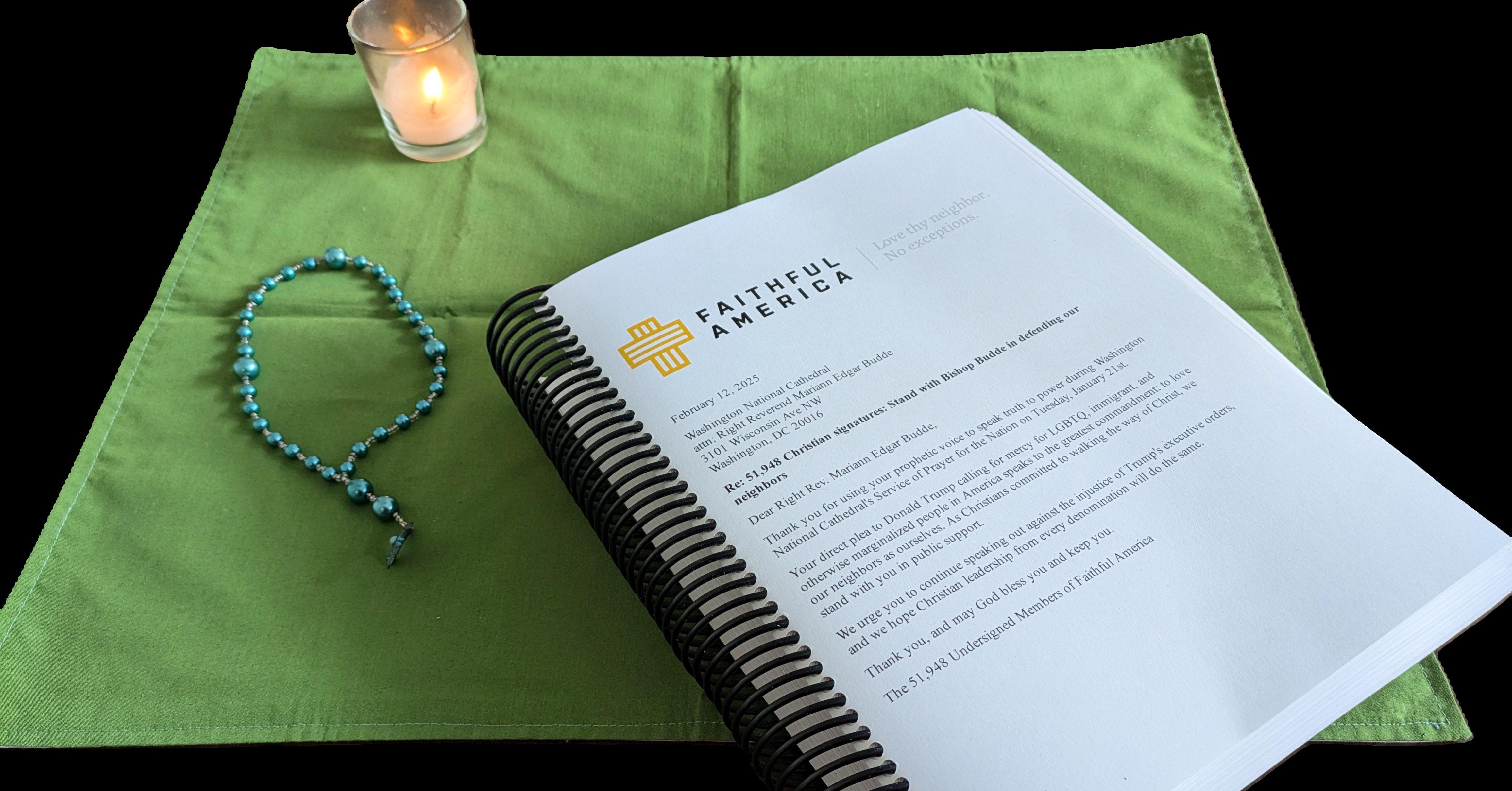 Green prayer mat with a lit candle, prayer beads, and a copy of a thank you petition to Bishop Budde