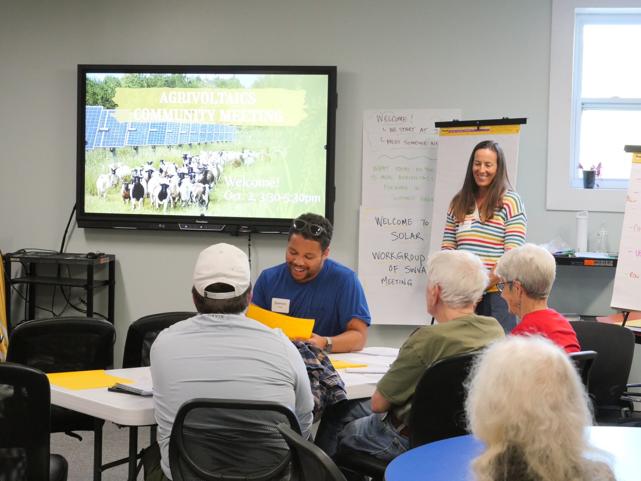 Facilitator and community members participate in an activity during a Solar Workgroup community meeting. 