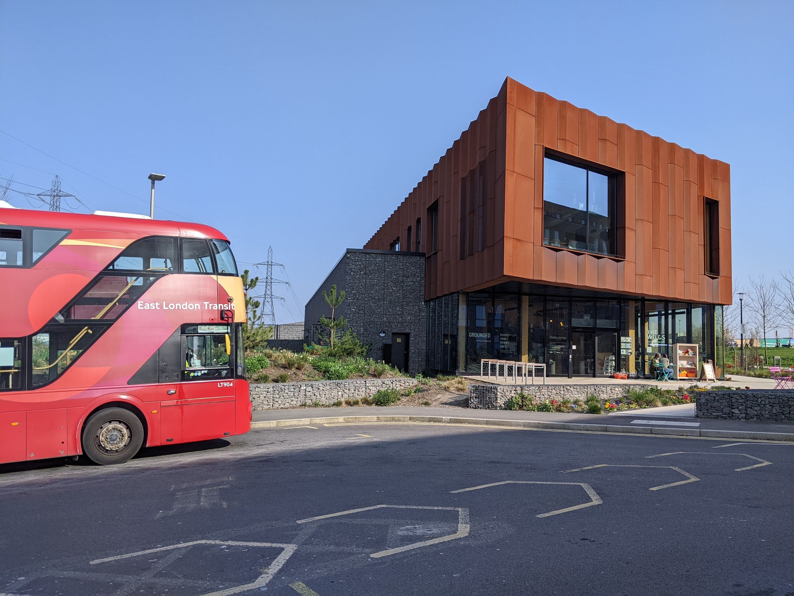 Modern building with red bus