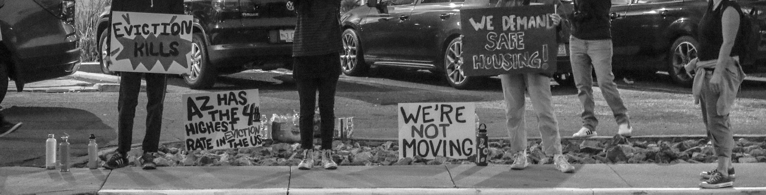 Protestors with signs that state "Eviction kills", "AZ has the 4th highest eviction rate in the US", "We're not moving", and "We demand safe housing!"