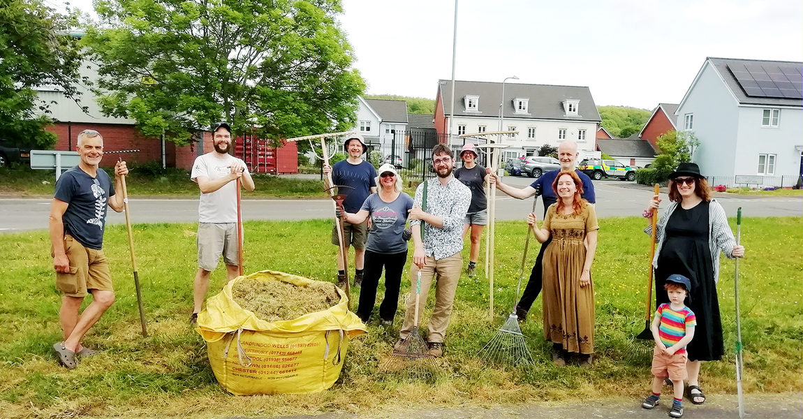 Members of Nature by the Taff standing by a bulk bag of raked hay