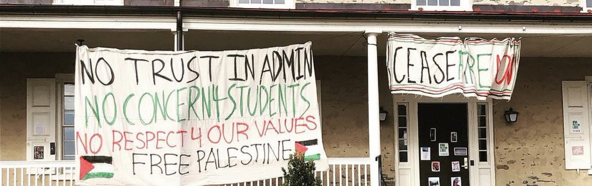 Image of Founders Hall at Haverford College, with two large banners hanging. One banner reads "NO TRUST IN ADMIN NO CONCERN 4 STUDENTS NO RESPECT 4 OUR VALUES FREE PALESTINE". The other banner reads "CEASEFIRE NOW"