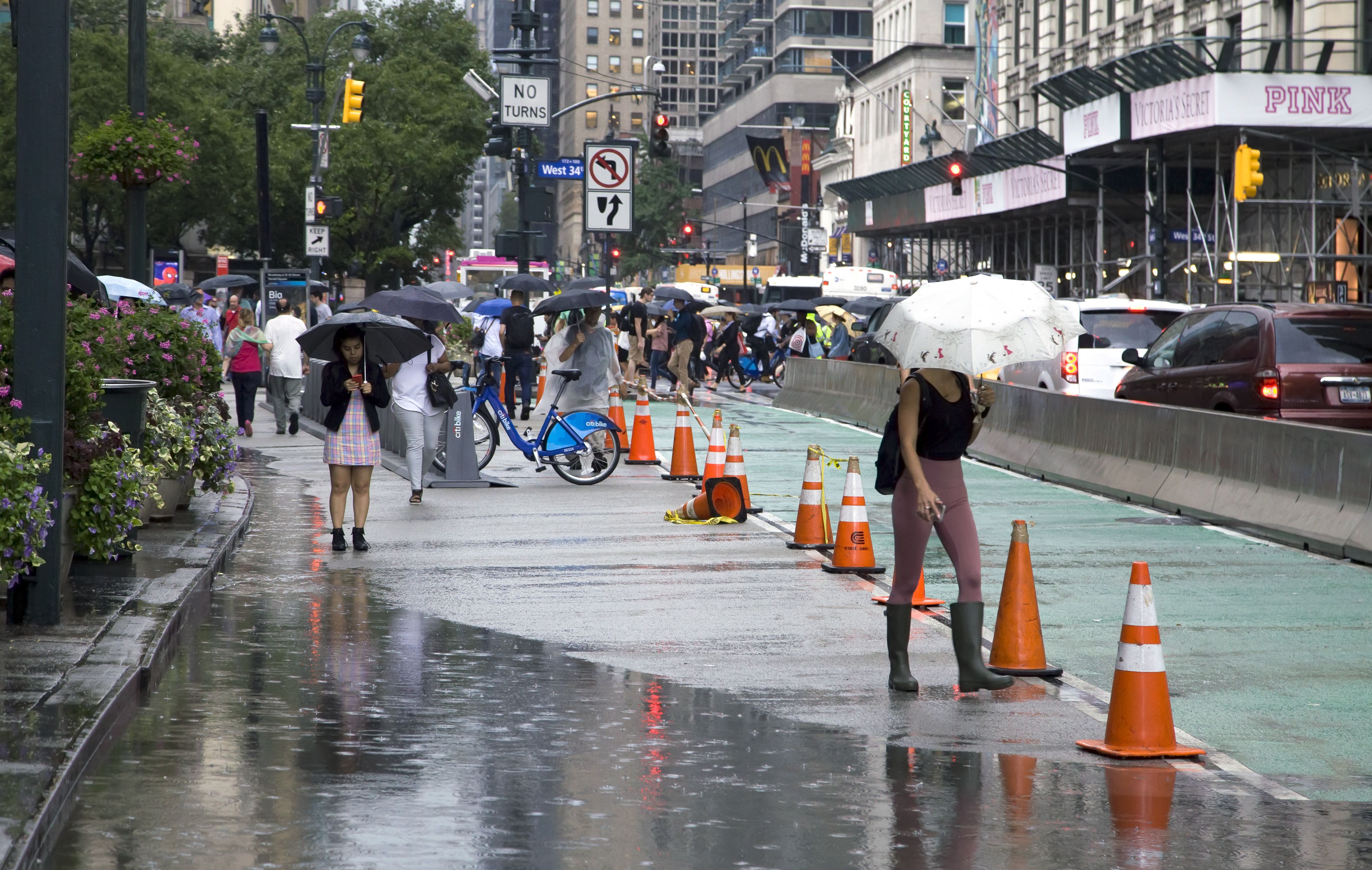 New Yorkers walking in heavy rain.