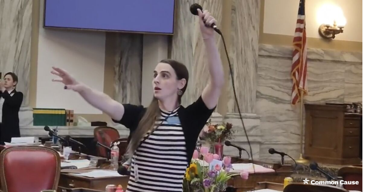 Rep. Zooey Zephyr holding her microphone in the air