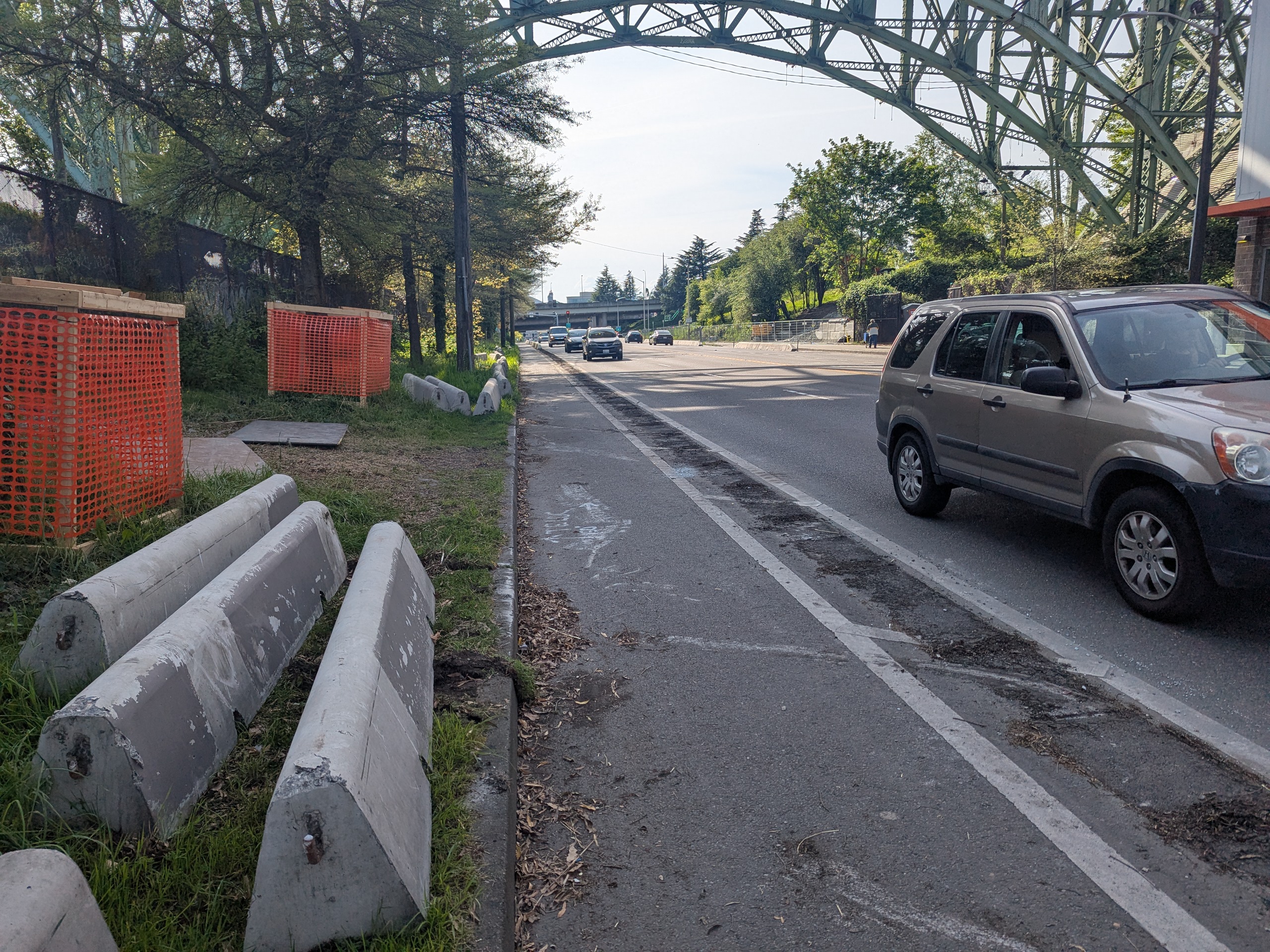 Photo of unprotected bike lane with the concrete protection placed in the planting strip.