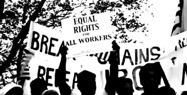 Sillouhette of workers holding up signs that says "Equal Rights for All Workers" and "Break the Chains"
