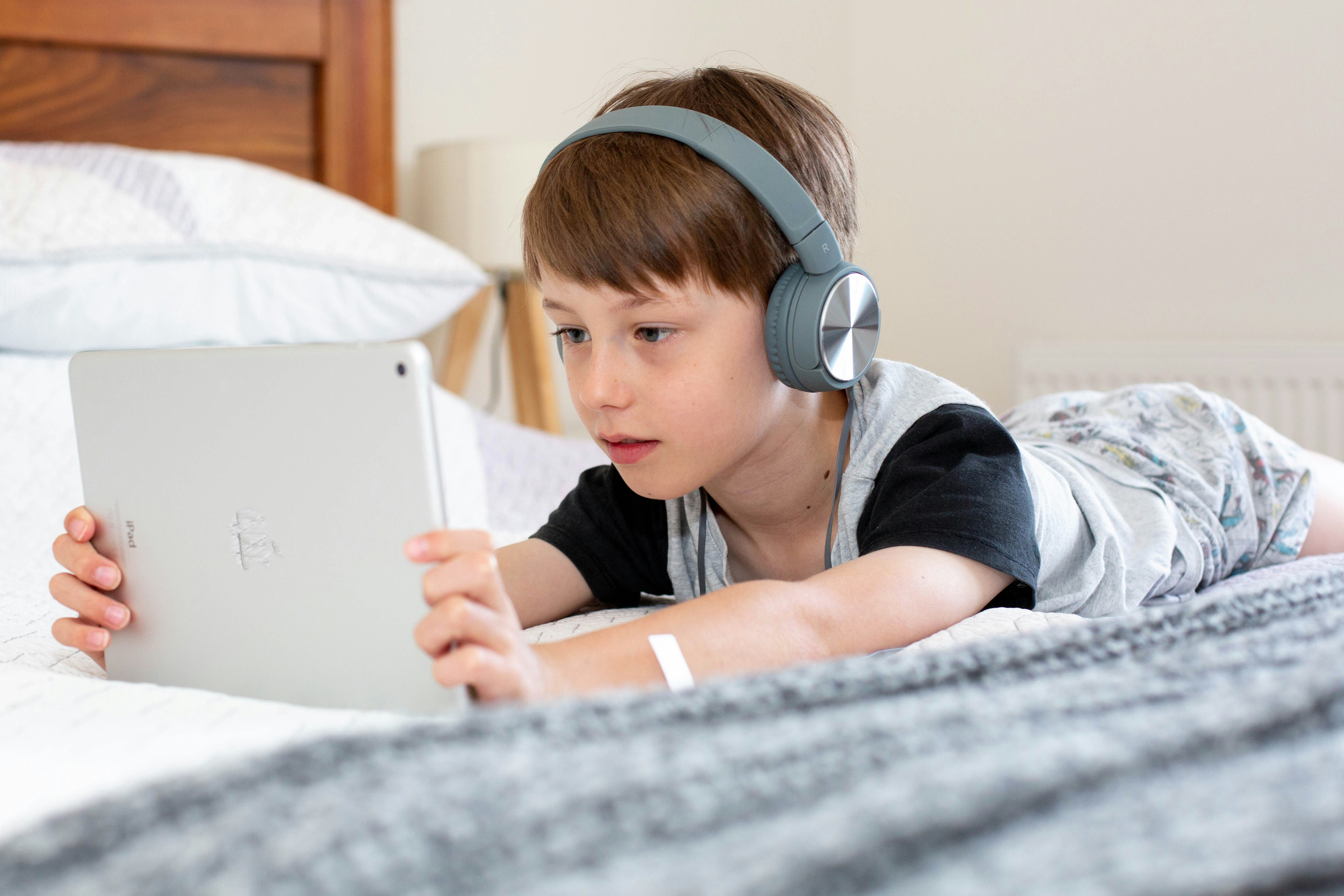 Young boy plays with ipad.