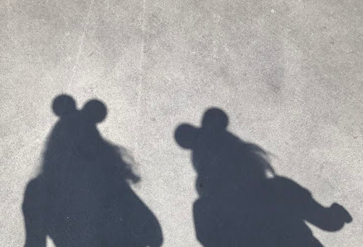 Shadow of girls wearing Mickey Mouse Ears.