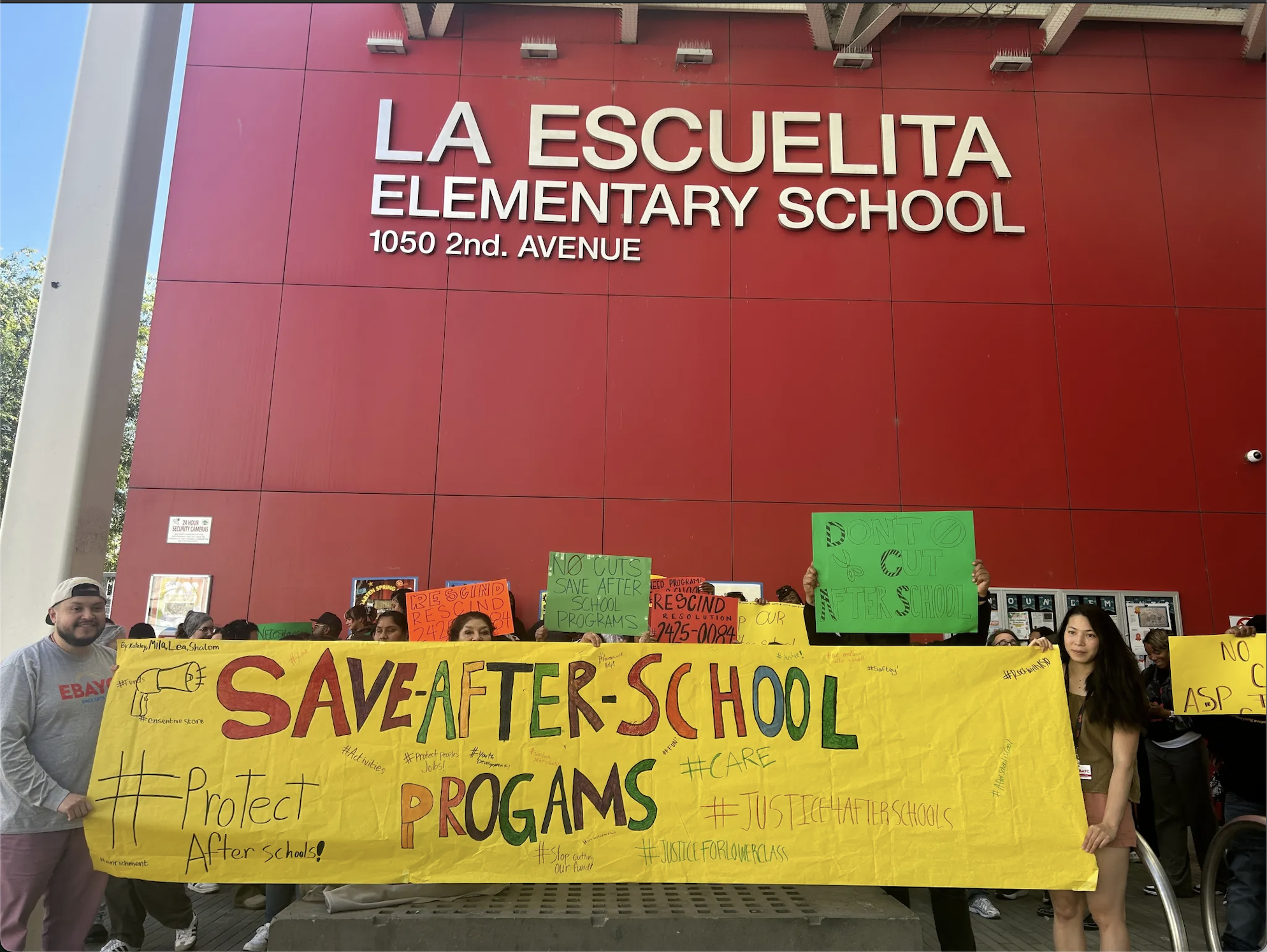Staff and supporters of after-school programs in Oakland rally ahead of a school board meeting to urge district leaders to rescind program cuts on May 21, 2025. 