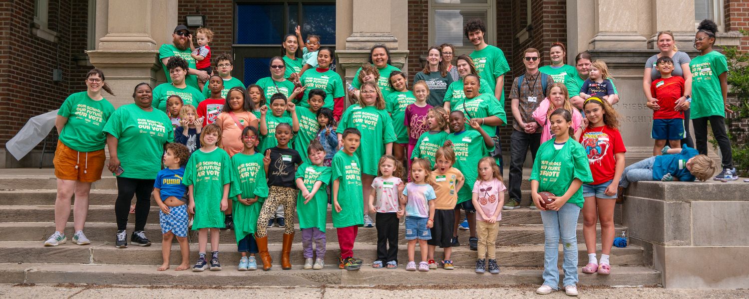 diverse group of kids and adults rallying for safe green schools