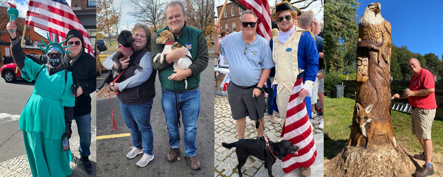 Rob Strickler with wife and dogs, American flag and eagle carving