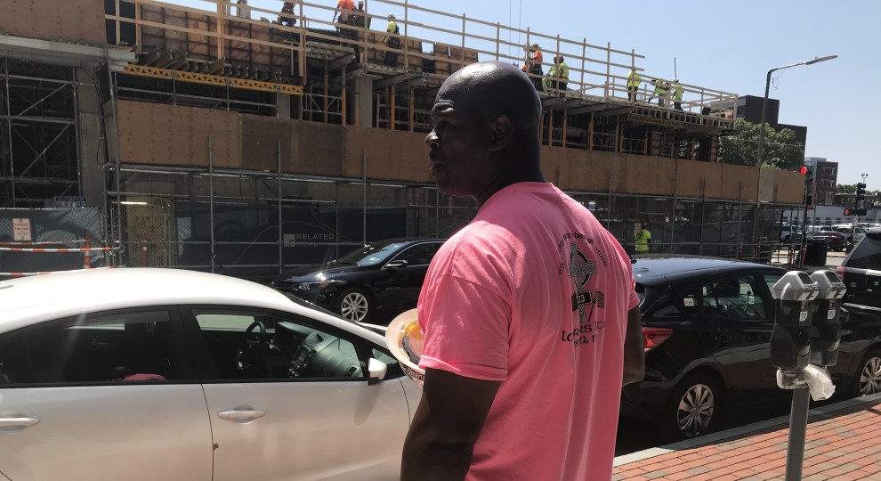 Darius Hines stands in front of a construction site on Harrison Avenue where he's a labor steward for Local 223.