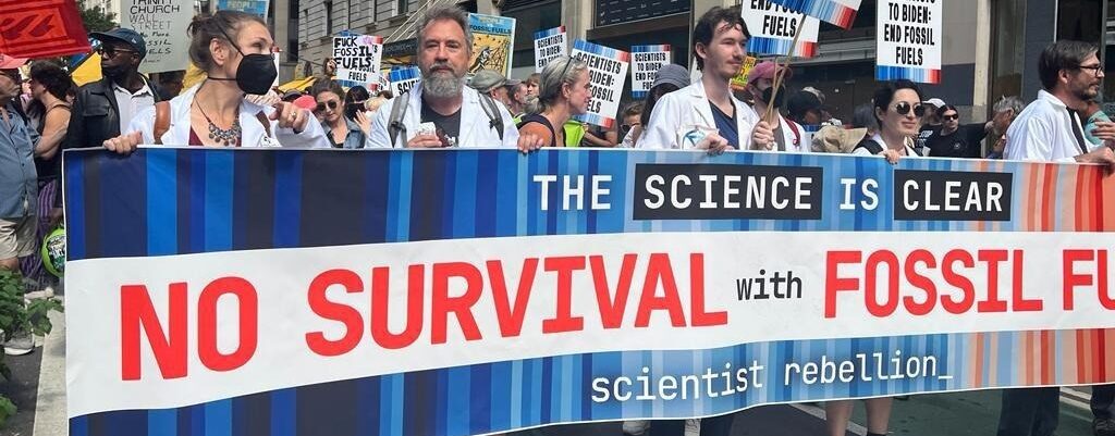 Scientist Rebellion Turtle Island demonstrators with banner reading The Science Is Clear: No Survival with Fossil Fuels - scientist rebellion_