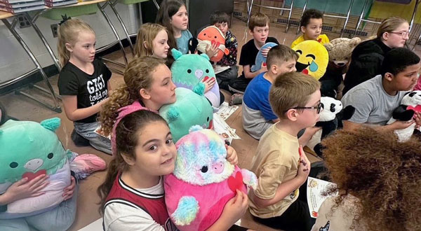 Children at Welch Elementary in McDowell County, W.Va., participate in Reading Buddy Adoption Day, an activity held to welcome them back to school after devastating floods.