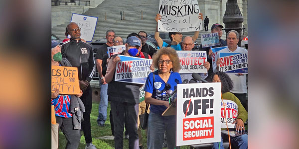 Retiree Brenda Marks speaks at a rally.