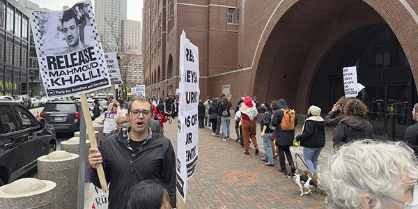 People protesting with signs that say "Release Khalil"