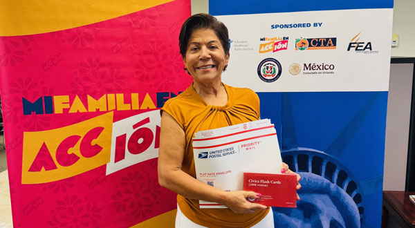 Smiling woman holding a mailing envelope