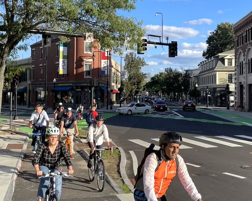People biking in a protected bike lane in People biking in a protected bike lane in