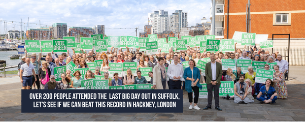 Group of over 200 people on Ipswich Waterfront in Suffolk, holding Green Party posterboards