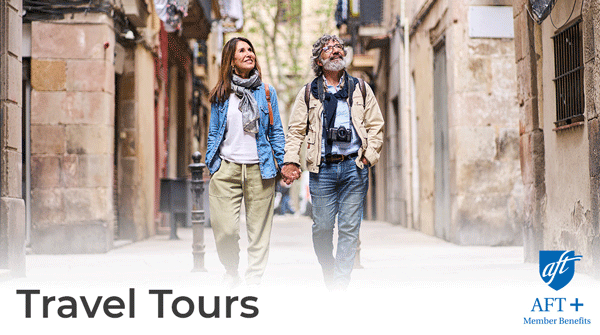 Two people walking hand in hand down a historic street