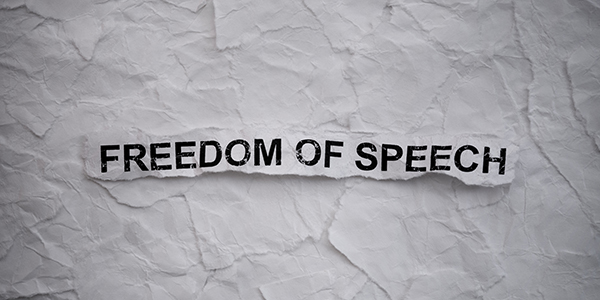 Torn piece of paper that says "FREEDOM OF SPEECH"