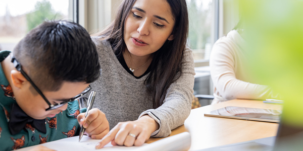 A teacher helping a special education student