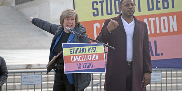 Randi Weingarten at a podium with a sign on it that says "Student debt cancellation is legal" Randi Weingarten at a podium with a sign on it that says "Student debt cancellation is legal"