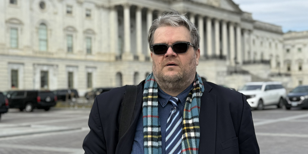 Tom Moomjy looking exhausting standing in front of the Capitol building
