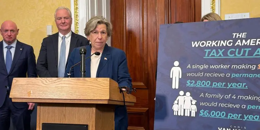 Randi Weingarten behind podium next to an infographic