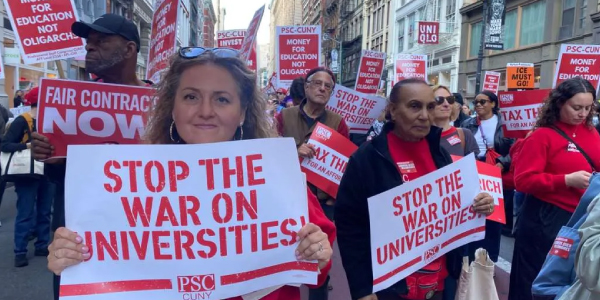 Protestors march on a street to speak out against attacks on higher education.