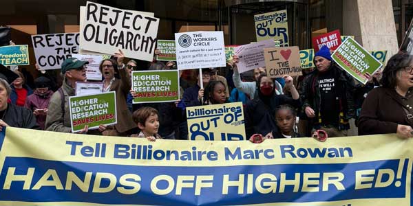 Protestors hold up a sign that reads, "Tell Billionaire Marc Rowan HANDS OFF HIGHER ED!"