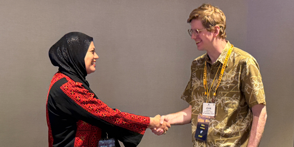 An AFT staff member greets an in international guest at the convention. An AFT staff member greets an in international guest at the convention.