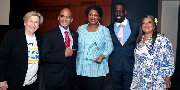 AFT leaders pose with award recipient Stacey Abrams. AFT leaders pose with award recipient Stacey Abrams.
