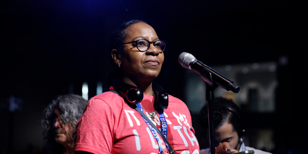 Delegate speaking at a microphone during the AFT convention. Delegate speaking at a microphone during the AFT convention.