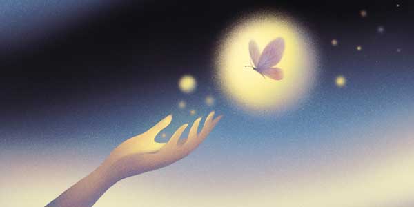 A hand reaches out to touch a butterfly. 