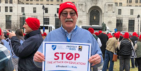 Jim Carr holding a sign Jim Carr holding a sign