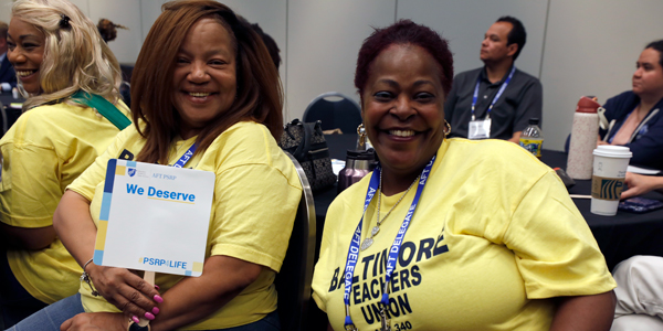 Two members of the Baltimore Teachers Union, wearing yellow BTU T-shirts, during their PSRP divisional meeting at the Washington, D.C., Convention Center.